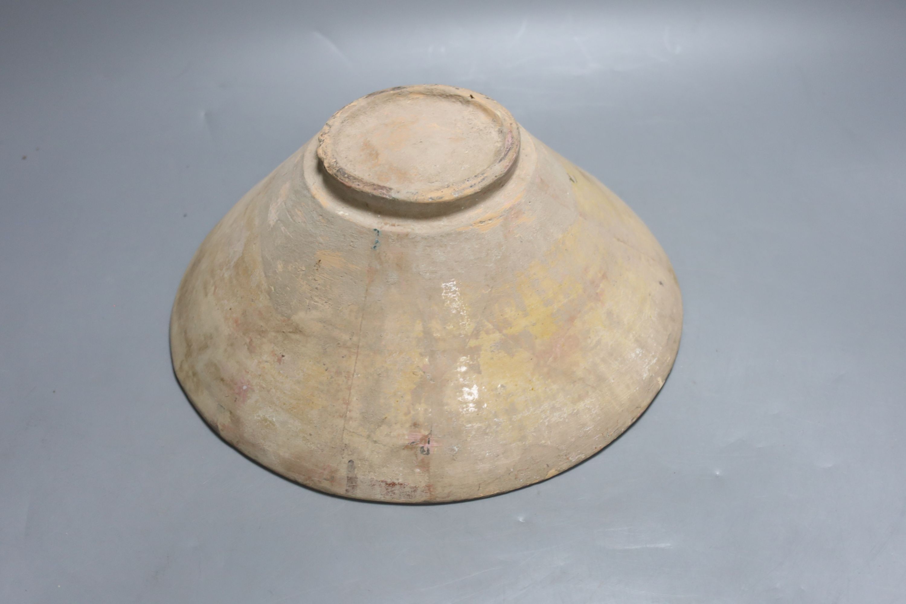 An Islamic bowl with kufic script, diameter 24cm
